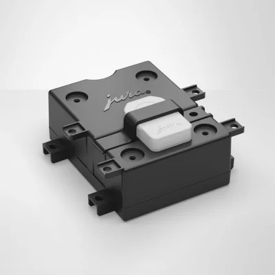 Un composant électronique rectangulaire noir étiqueté « MDB Interface 2.0 » avec un interrupteur blanc sur le dessus. Il comporte plusieurs trous de montage sur les côtés et est placé sur un fond uni gris clair.